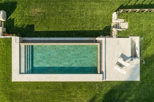 an overhead view of a swimming pool in the grass at Il Giuncheto in Trequanda