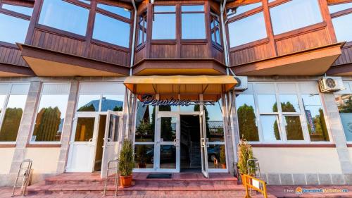 a building with a building with a revolving door at Anomis in Cîmpulung