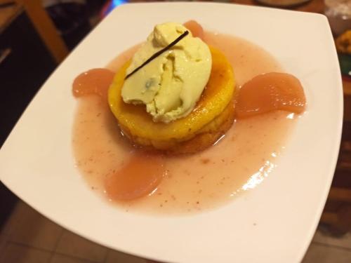 a dessert with ice cream and sauce on a white plate at Mas Lo Faix in Saint-Laurent-de-Cerdans