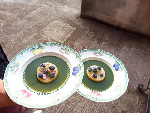 two plates with donuts with blueberries on them at Mas Lo Faix in Saint-Laurent-de-Cerdans