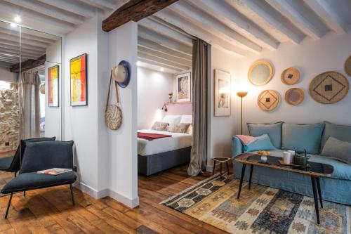 uma sala de estar com um sofá e uma cama em Boutik Boheme Le jardin Montmartre em Paris