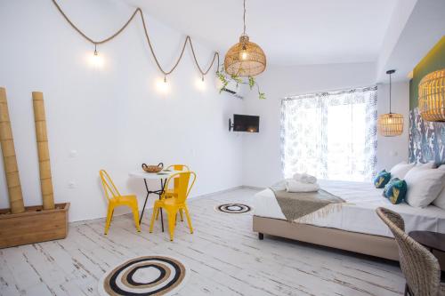 a bedroom with a bed and a table and chairs at Marini Seaside in Faliraki