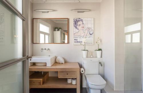 a bathroom with a sink and a toilet and a mirror at Stay U-nique Apartments Monec in Barcelona