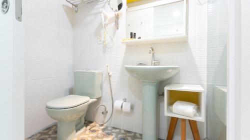 a bathroom with a toilet and a sink at Kembali Hotel Porto de Galinhas - Adults Only in Porto De Galinhas
