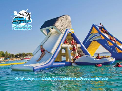 a group of people on a water slide at a water park at Unterkünfte bei Wake and Beach am Halbendorfer See in Schleife