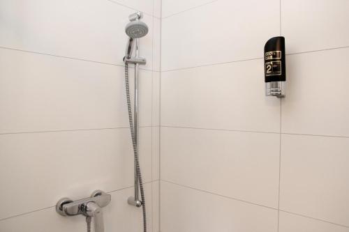 a shower with a shower head in a bathroom at Forsthaus am Möhnesee in Möhnesee