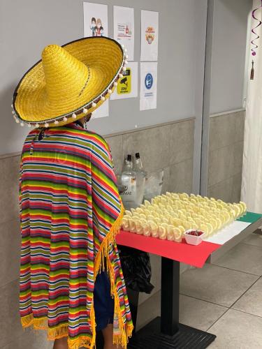 a person wearing a straw hat looking at a table of pastries at Hotel Sorra Daurada Splash in Malgrat de Mar