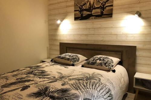 a bedroom with a bed with two pillows on it at Laon : « Suite privée au pied de la Cathédrale » in Laon