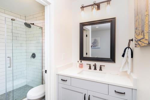 a white bathroom with a sink and a shower at Viking Lodge 109 - Viking Venue in Telluride