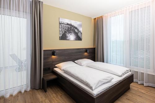 a bedroom with a bed with the eiffel tower at Hotel am Park in Rust