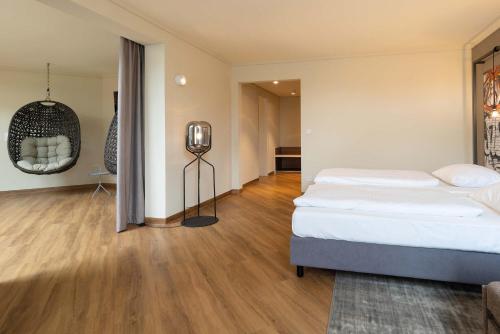 a large bedroom with two beds and a room with a floor at Seminaris Hotel Bad Boll in Bad Boll