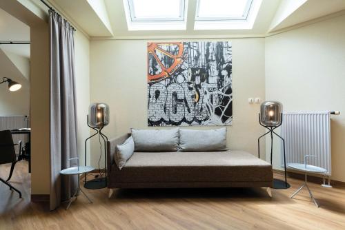 a couch in a room with a painting on the wall at Seminaris Hotel Bad Boll in Bad Boll