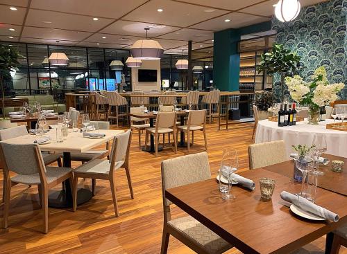 a restaurant with tables and chairs in a room at The Bradley in Fort Wayne