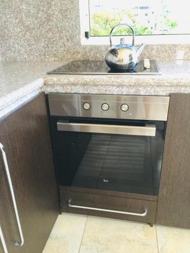 a kitchen with a stainless steel oven with a sink at Eco Hotel Katarma in Puerto Baquerizo Moreno