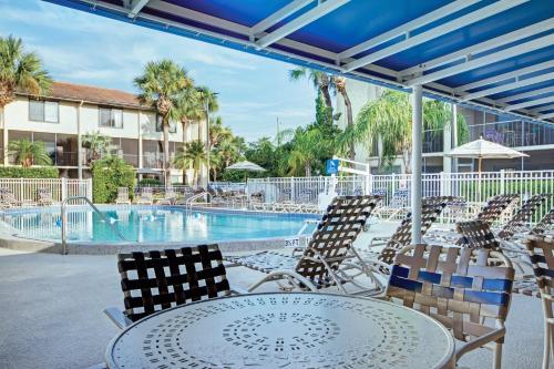 a patio with a table and chairs and a pool at Club Wyndham Orlando International in Orlando