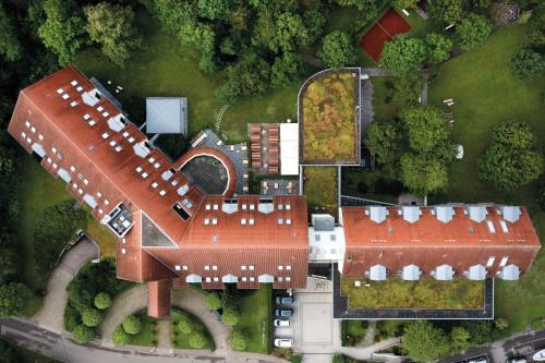 an overhead view of a house with a large roof at Seminaris Hotel Bad Boll in Bad Boll