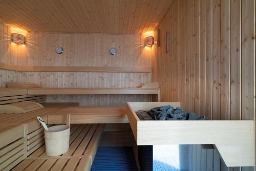 a sauna with wooden walls and a bench in it at Seminaris Hotel Bad Boll in Bad Boll