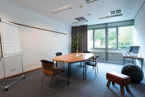 a conference room with a table and chairs in it at Seminaris Hotel Bad Boll in Bad Boll