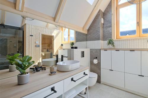 a bathroom with two sinks and a large window at Osada Bachledzki Wierch Odkryj Zakopane in Zakopane