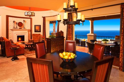 a dining room with a table with a bowl of fruit on it at Pueblo Bonito Montecristo Luxury Villas - All Inclusive in Cabo San Lucas