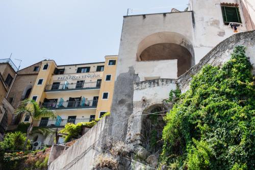 a building on a hill with a tree in front of it at Palazzo Vingius in Minori
