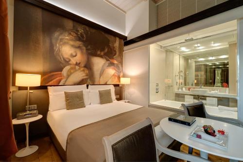 a bedroom with a bed and a painting of a woman at Villa Agrippina Gran Meliá – The Leading Hotels of the World in Rome