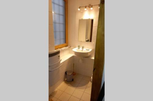 a bathroom with a sink and a mirror at Appartement de charme le 1707 au cœur de la cité Vauban in Briançon