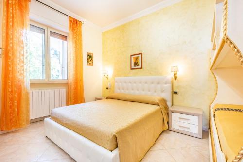 a bedroom with a bed with an orange curtain at Villa Vanessa in Leuca