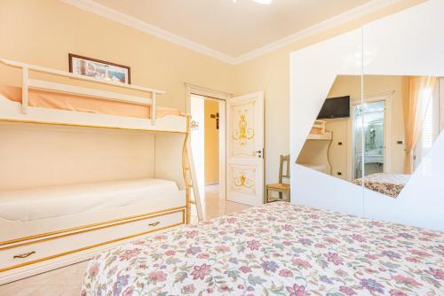 a bedroom with a bed and a mirror at Villa Vanessa in Leuca