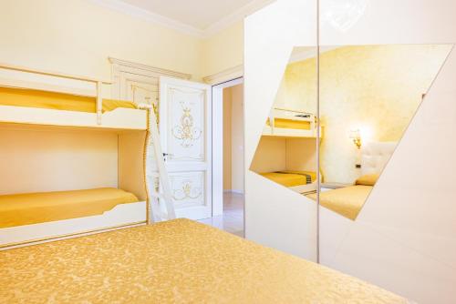 a room with two bunk beds and a mirror at Villa Vanessa in Leuca