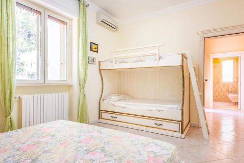 a bedroom with a bunk bed and a window at Villa Vanessa in Leuca