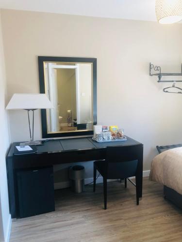a black desk with a mirror in a bedroom at The Annexe II in Mildenhall