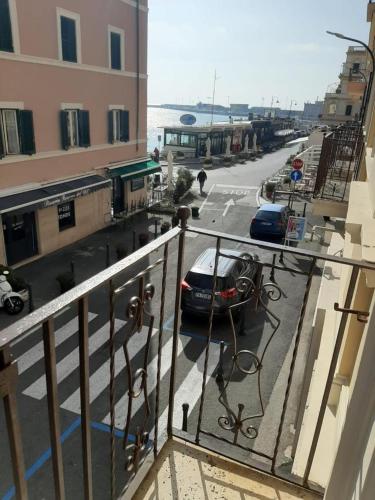 a balcony with a car parked on a street at PuraVida in Anzio