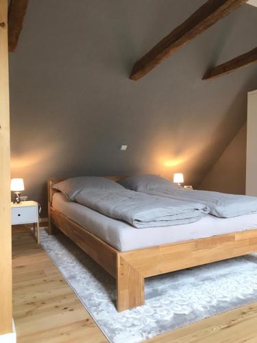 a bedroom with a wooden bed in a attic at Fachwerk-Maisonette-Wohnung -zur Tenne- in Rieste