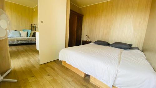 a bedroom with a large white bed in it at Le Gîte de Saint Phal in Saint-Phal