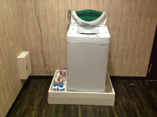 a washer and dryer in a room at Granvillage Toya Daiwa Ryokan Annex in Lake Toya