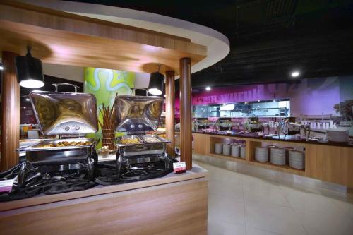 a restaurant with a buffet of food on display at favehotel PGC Cililitan in Jakarta