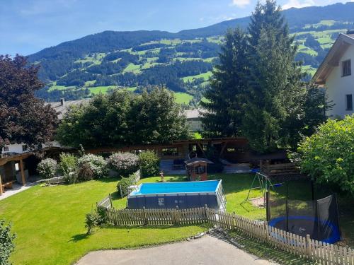 a view of a yard with a swimming pool at Ferienhof Kampfl in Fügen