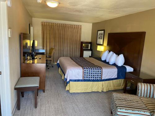 A bed or beds in a room at Vino Inn & Suites
