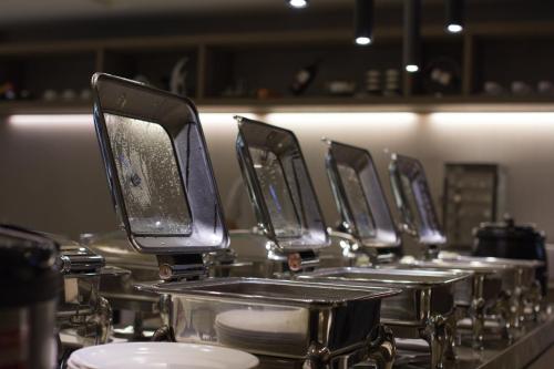 a row of drums on a counter in a kitchen at Royal Guest Hotel in Tainan