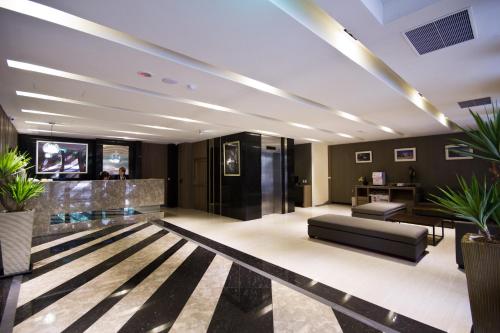 a lobby with a couch and some plants at Royal Guest Hotel in Tainan