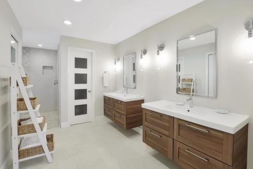 a bathroom with two sinks and a ladder in it at 216 Shadowridge Court in Marco Island