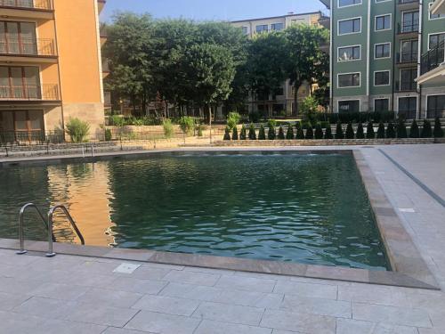 a swimming pool in the middle of a building at Rabi Park Residence in Varna City