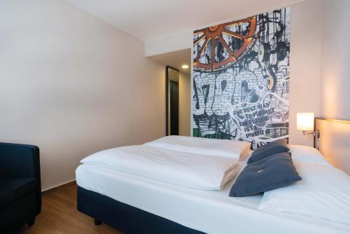 a bedroom with a bed with a mural on the wall at Seminaris Hotel Bad Honnef in Bad Honnef am Rhein