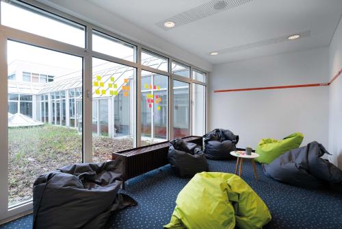 a living room with bean bags and a large window at Seminaris Hotel Bad Honnef in Bad Honnef am Rhein