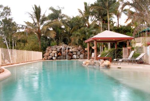 a large swimming pool with a gazebo in a resort at at Boathaven Bay Holiday Apartments in Airlie Beach