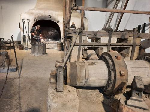 a man is standing in front of an oven at V přírodě na okraji Frenštátu pod Radhoštěm in Frenštát pod Radhoštěm