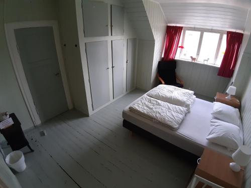 a small bedroom with a bed and a window at Det Gule Huset Hurdal in Hurdal