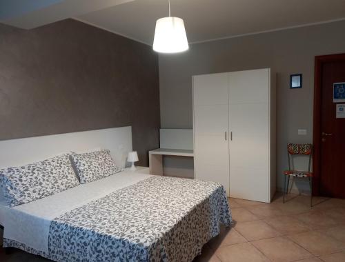 a bedroom with a bed and a white cabinet at Radices Bed & Breakfast in Campobasso