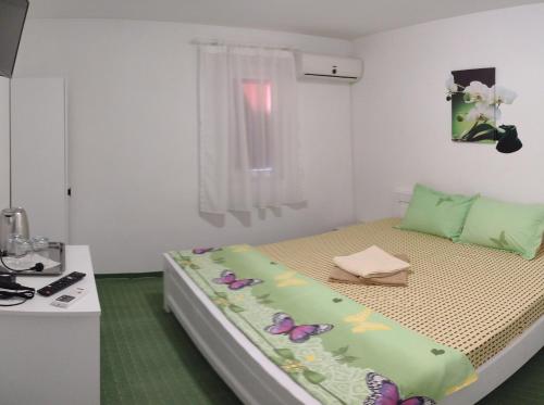 Un pat sau paturi într-o cameră la Vila Atipic